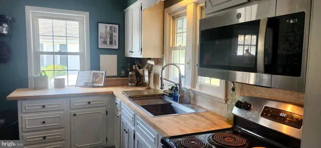 a kitchen with a sink stove and cabinets