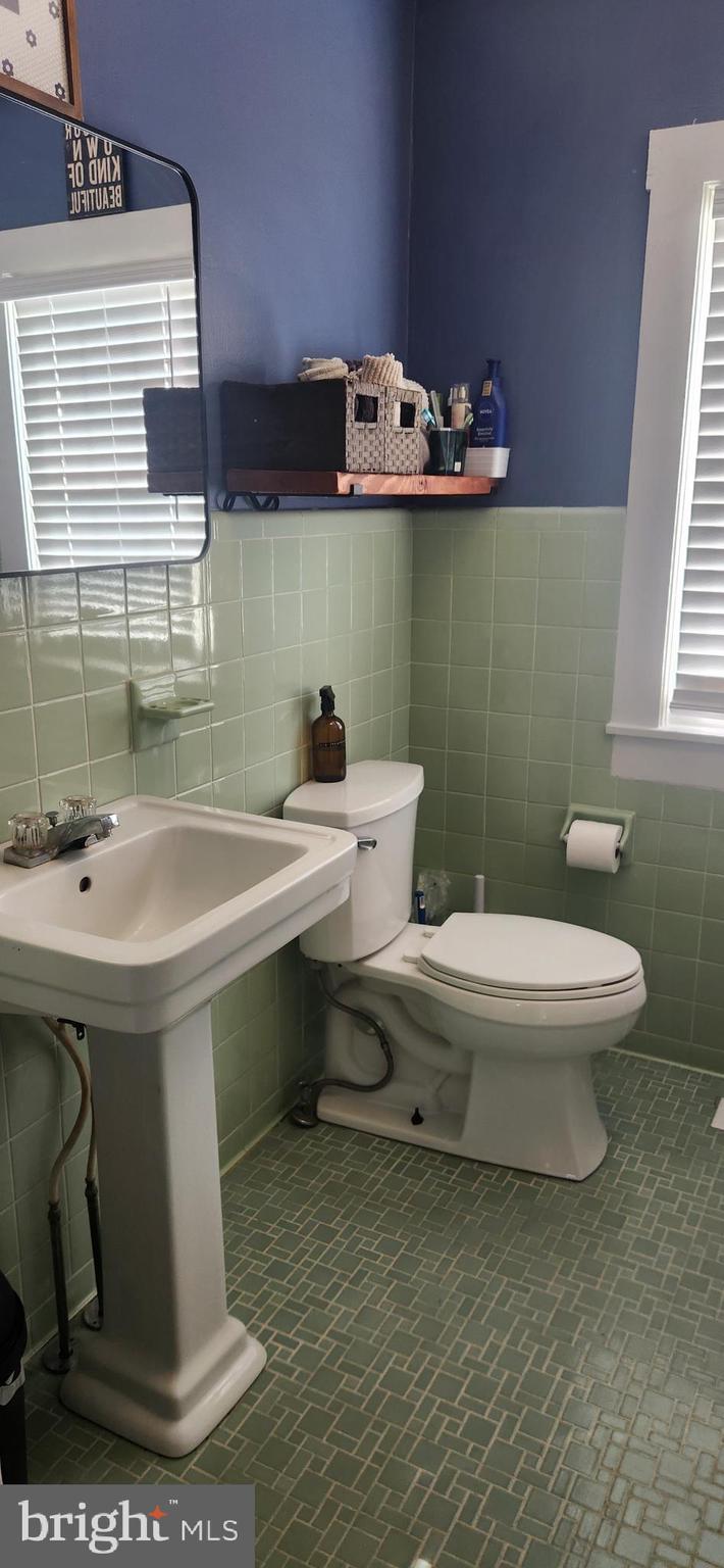 2001 Rhodesdale Vienna Vienna, MD 21869 - Photo 19 of 39 a bathroom with a sink a toilet and mirror