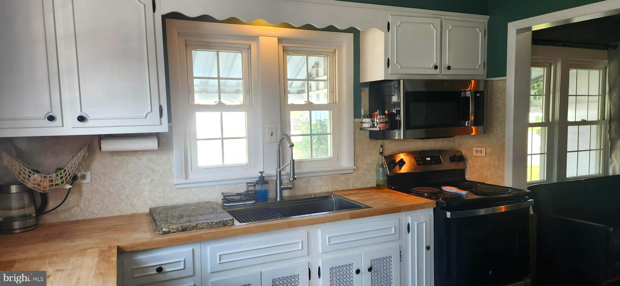 2001 Rhodesdale Vienna Vienna, MD 21869 - Photo 21 of 39 a kitchen with granite countertop a sink a stove and cabinets