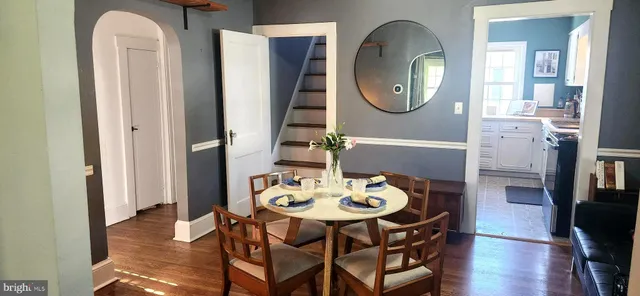 a view of a dining room with furniture and a mirror