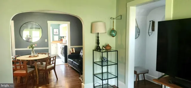 a living room with furniture and a mirror