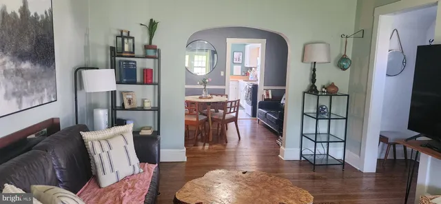 a living room with furniture fireplace and wooden floor