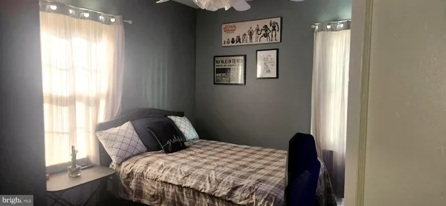 a bedroom with a bed and a window