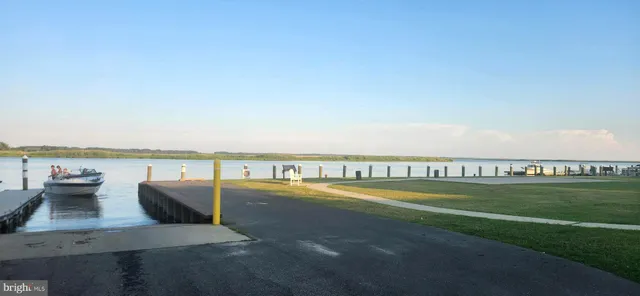 a view of a swimming pool with a terrace and seating space