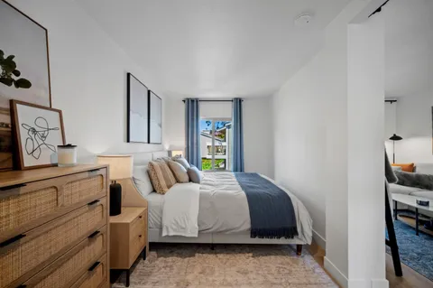 a bedroom with a bed and a window