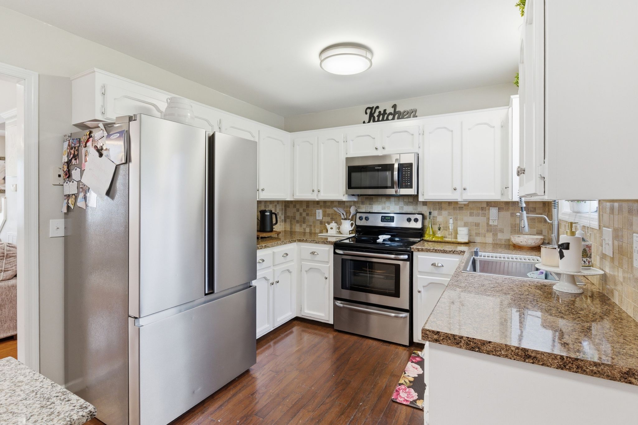 1140 Campbell Road Goodlettsville, TN 37072 - Photo 7 of 33 a kitchen with granite countertop a refrigerator a stove top oven a sink and dishwasher