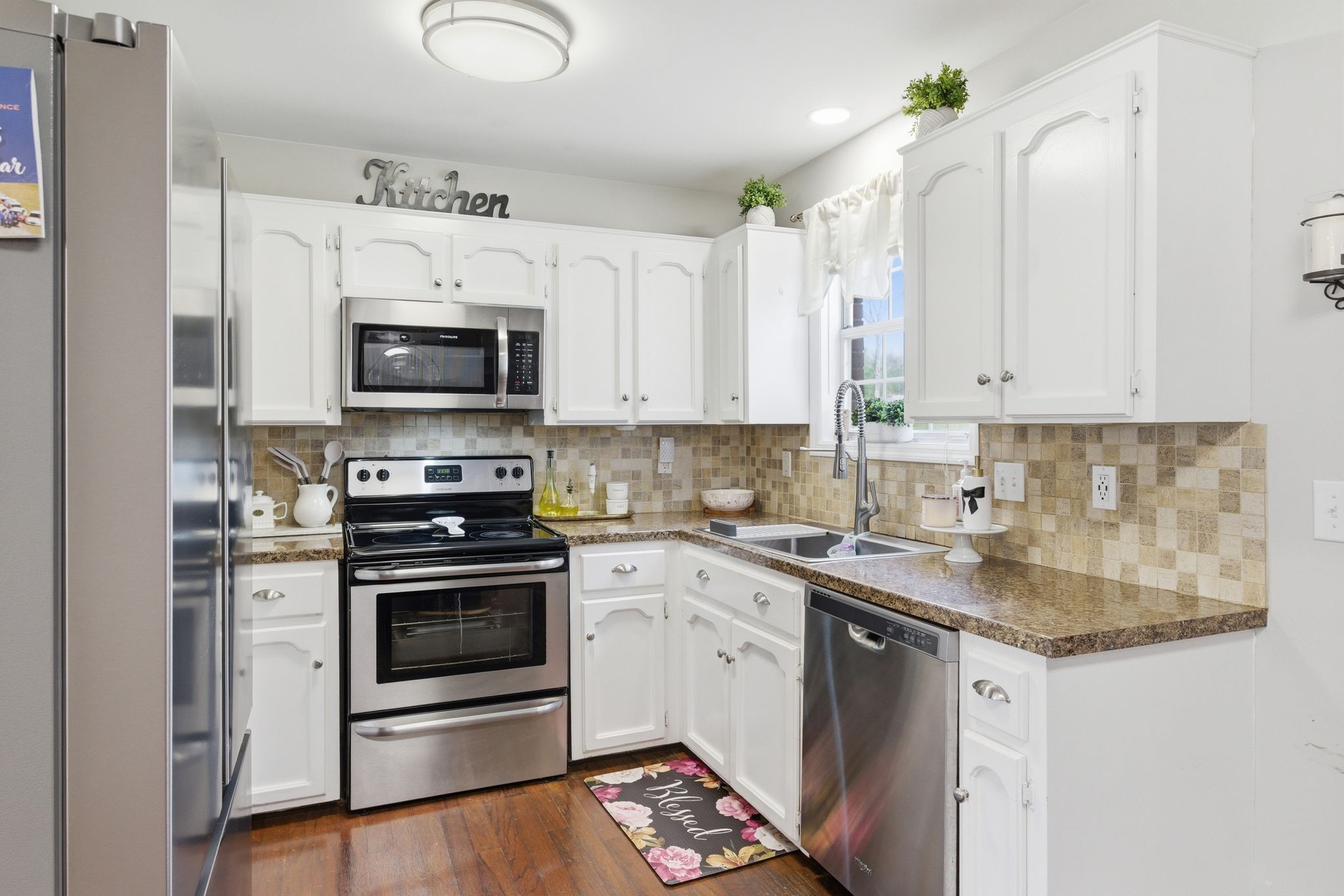 1140 Campbell Road Goodlettsville, TN 37072 - Photo 8 of 33 a kitchen with stainless steel appliances granite countertop a stove a sink and a microwave