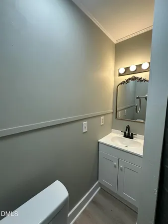 a bathroom with a sink a toilet and mirror