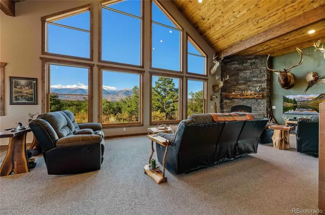 a living room with furniture fireplace and a large window