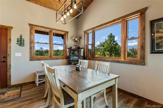 a living room with fireplace furniture and a large window