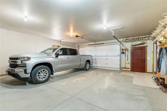 a view of a garage with a car and a car parked