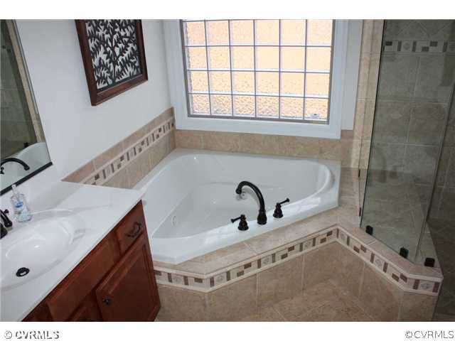 4018 Bircham Loop Midlothian, VA 23113 - Photo 8 of 12 a bathroom with a tub sink and mirror