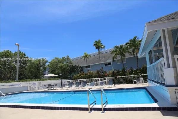 a view of a swimming pool with a chair and tables