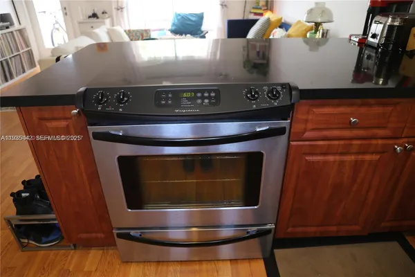 a stove top oven sitting inside of a kitchen