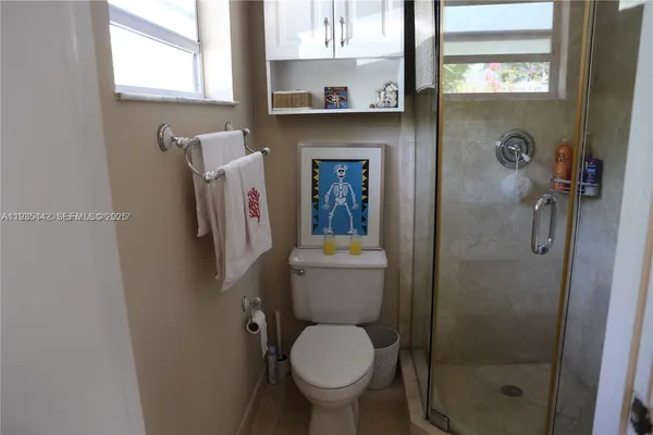 a white toilet sitting next to a bathroom sink