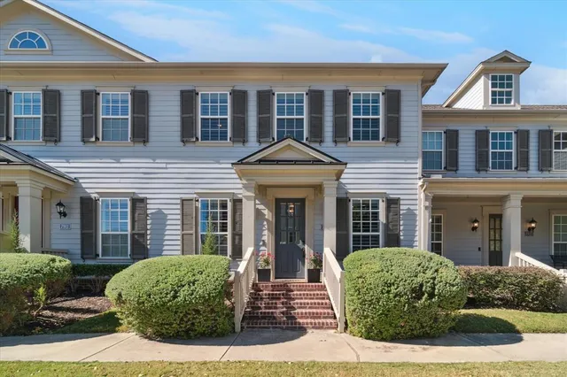 a front view of a house with yard and green space