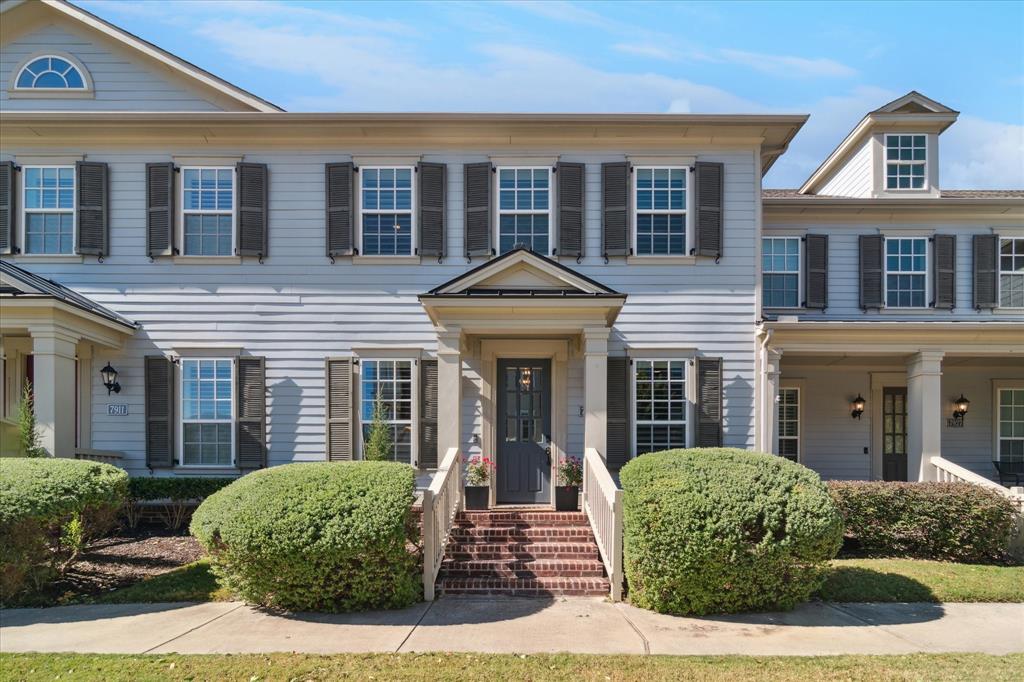 a front view of a house with yard and green space