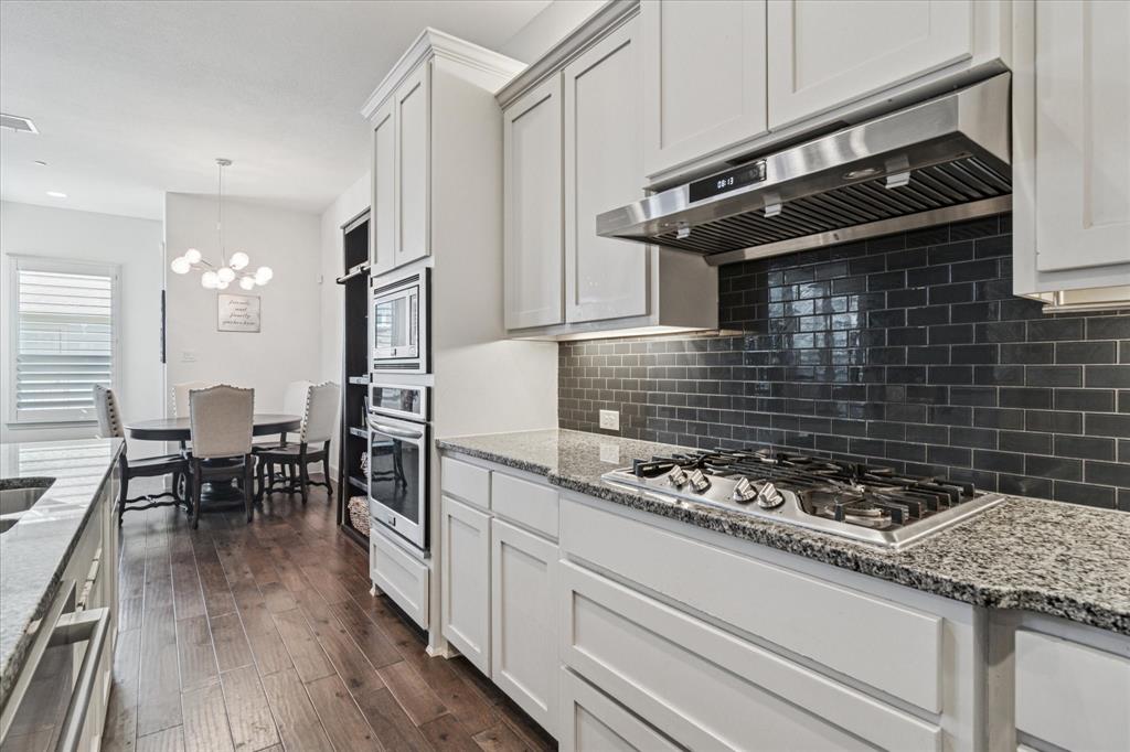 7919 Canal Street Frisco, TX 75034 - Photo 11 of 36 a kitchen with granite countertop stainless steel appliances and wooden cabinets