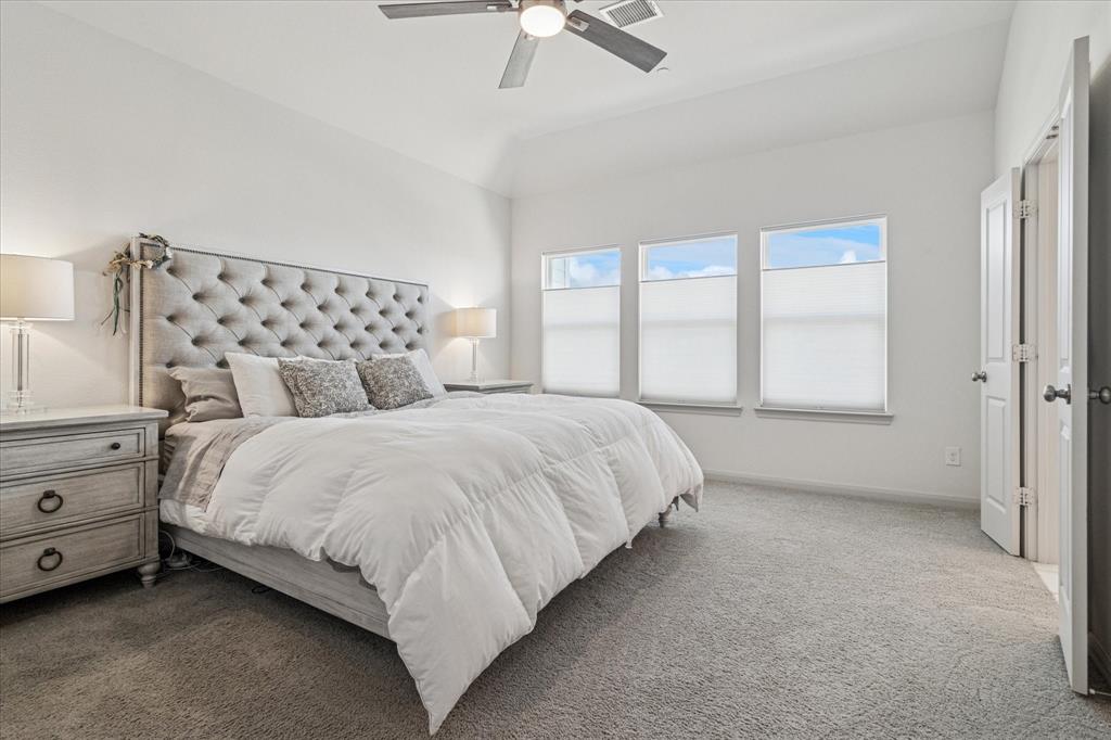 7919 Canal Street Frisco, TX 75034 - Photo 18 of 36 a large bed sitting in a bedroom next to a window