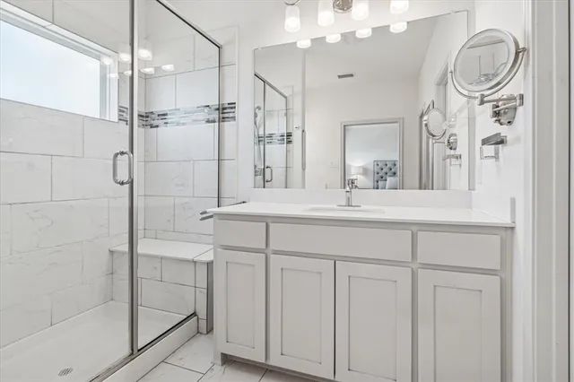 a bathroom with a granite countertop sink mirror and vanity