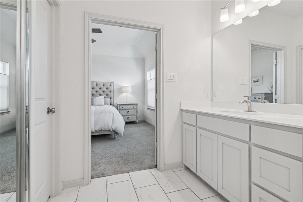 7919 Canal Street Frisco, TX 75034 - Photo 23 of 36 a en suite bathroom with a sink and mirror