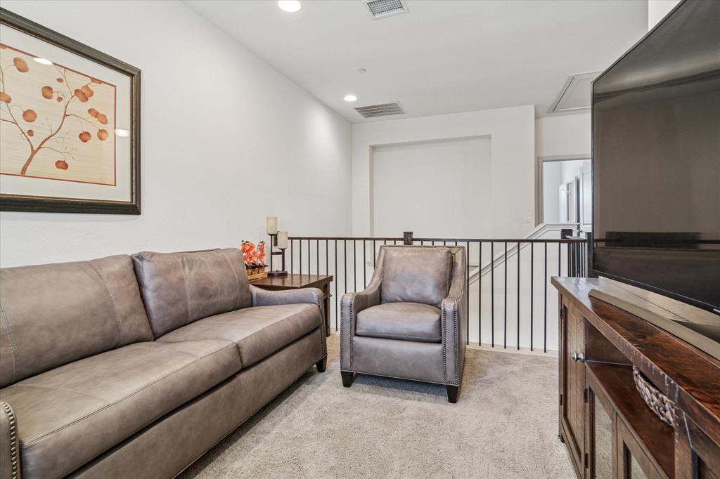 7919 Canal Street Frisco, TX 75034 - Photo 27 of 36 a living room with furniture and a flat screen tv