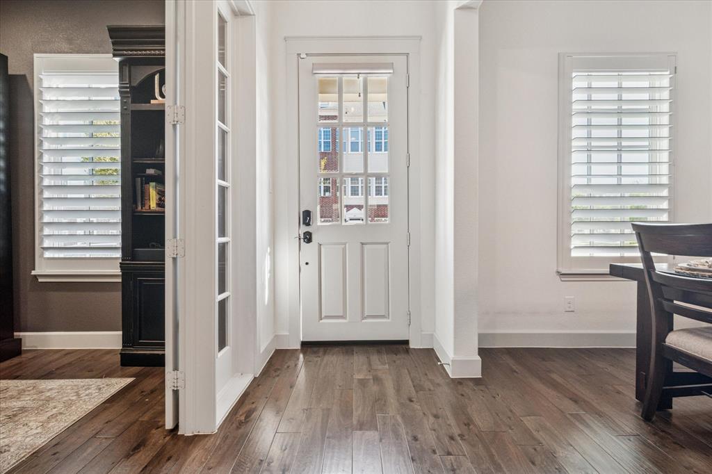 7919 Canal Street Frisco, TX 75034 - Photo 3 of 36 a view of a hallway with wooden floor and a bathroom