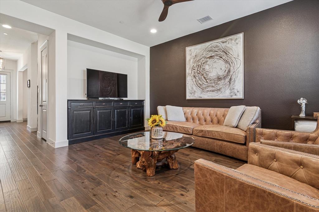 7919 Canal Street Frisco, TX 75034 - Photo 6 of 36 a living room with furniture and a flat screen tv