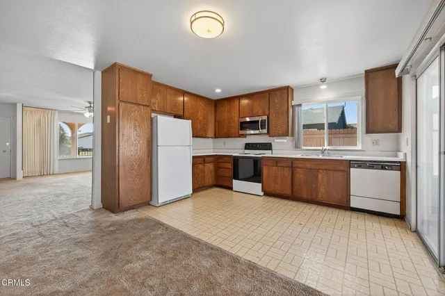 a large kitchen with a refrigerator and a sink