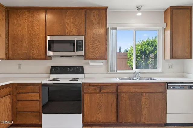 a kitchen with a sink stove and microwave