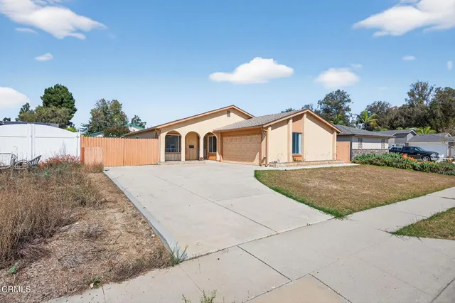 a view of house with yard and entertaining space