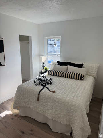 47 B Street Helper, UT 84526 - Photo 11 of 19 Bright interior space featuring wood-finish flooring, a window with natural light, a neutral color palette, and an open closet area
