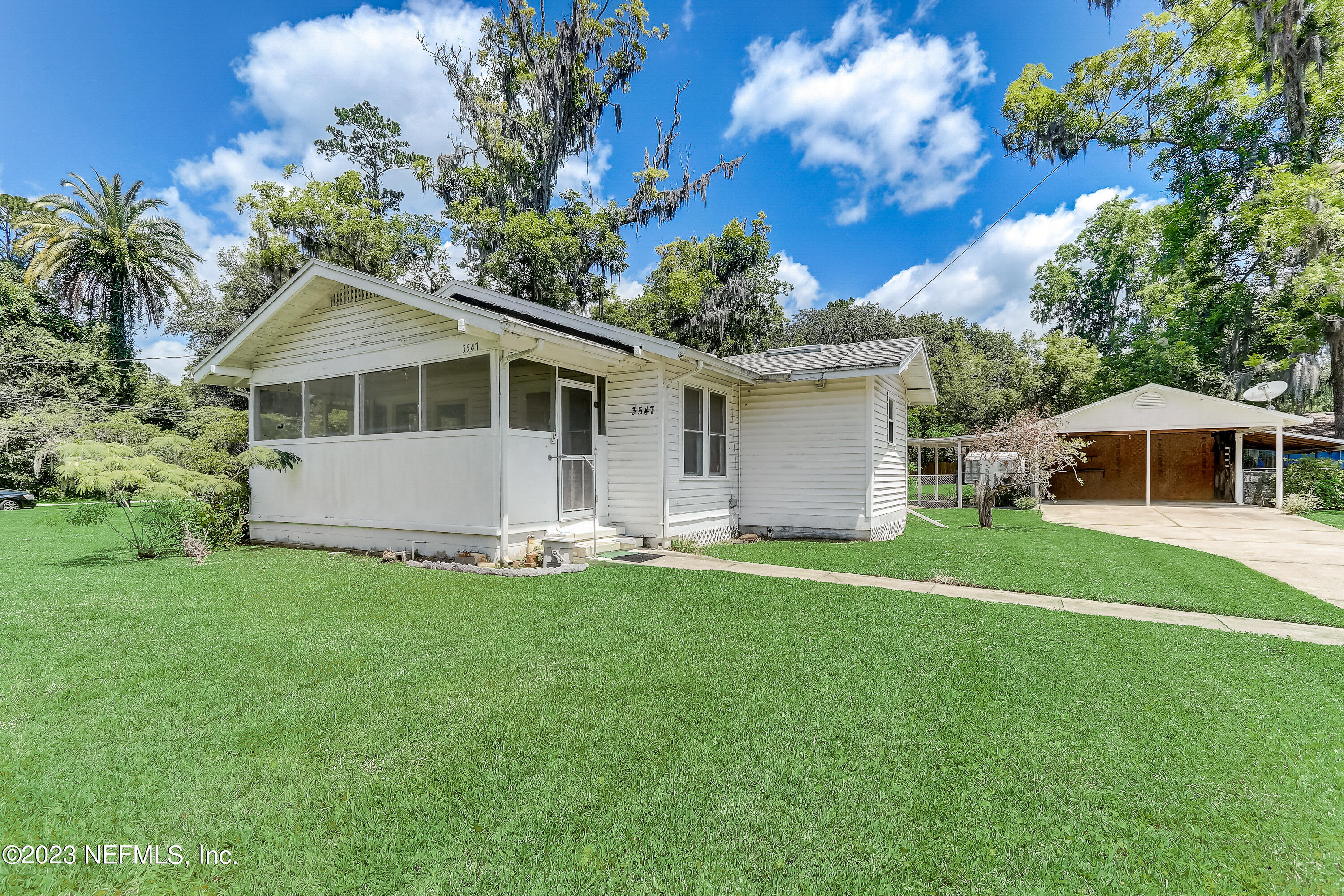 3547 Capper Road Jacksonville, FL 32218 - Photo 1 of 24 a front view of a house with a garden and trees