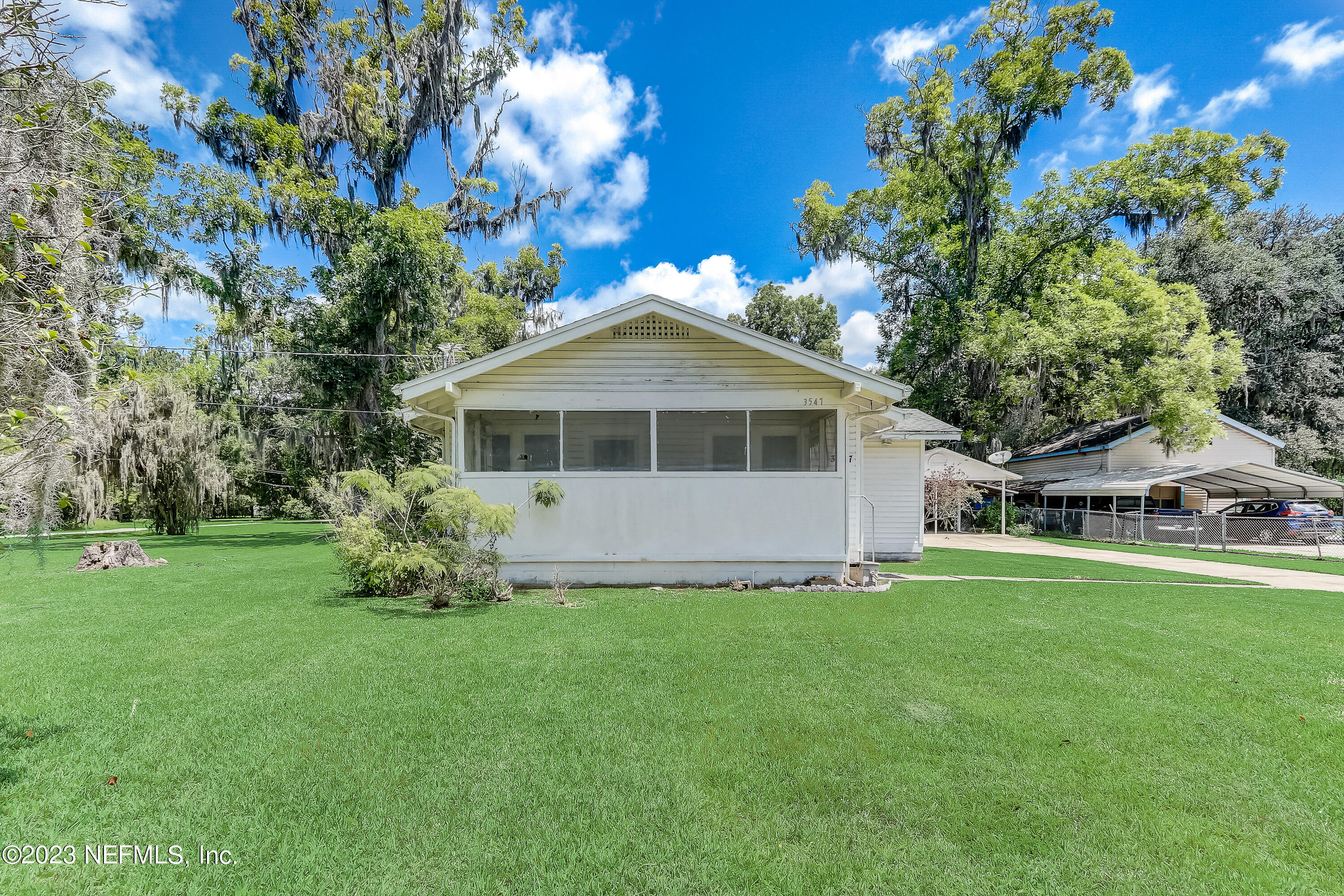 3547 Capper Road Jacksonville, FL 32218 - Photo 2 of 24 a front view of a house with a garden