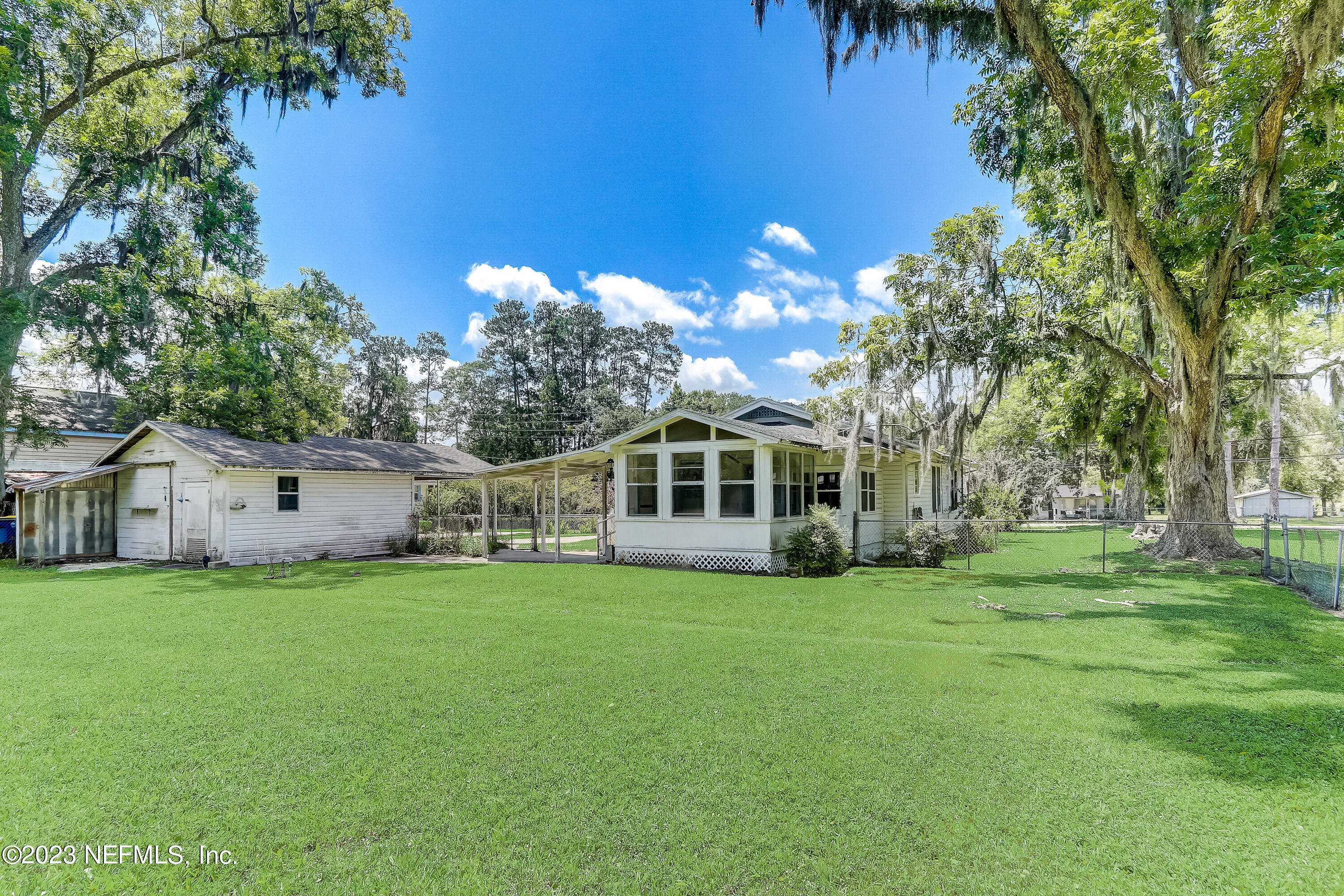 3547 Capper Road Jacksonville, FL 32218 - Photo 21 of 24 a front view of a house with a yard and trees