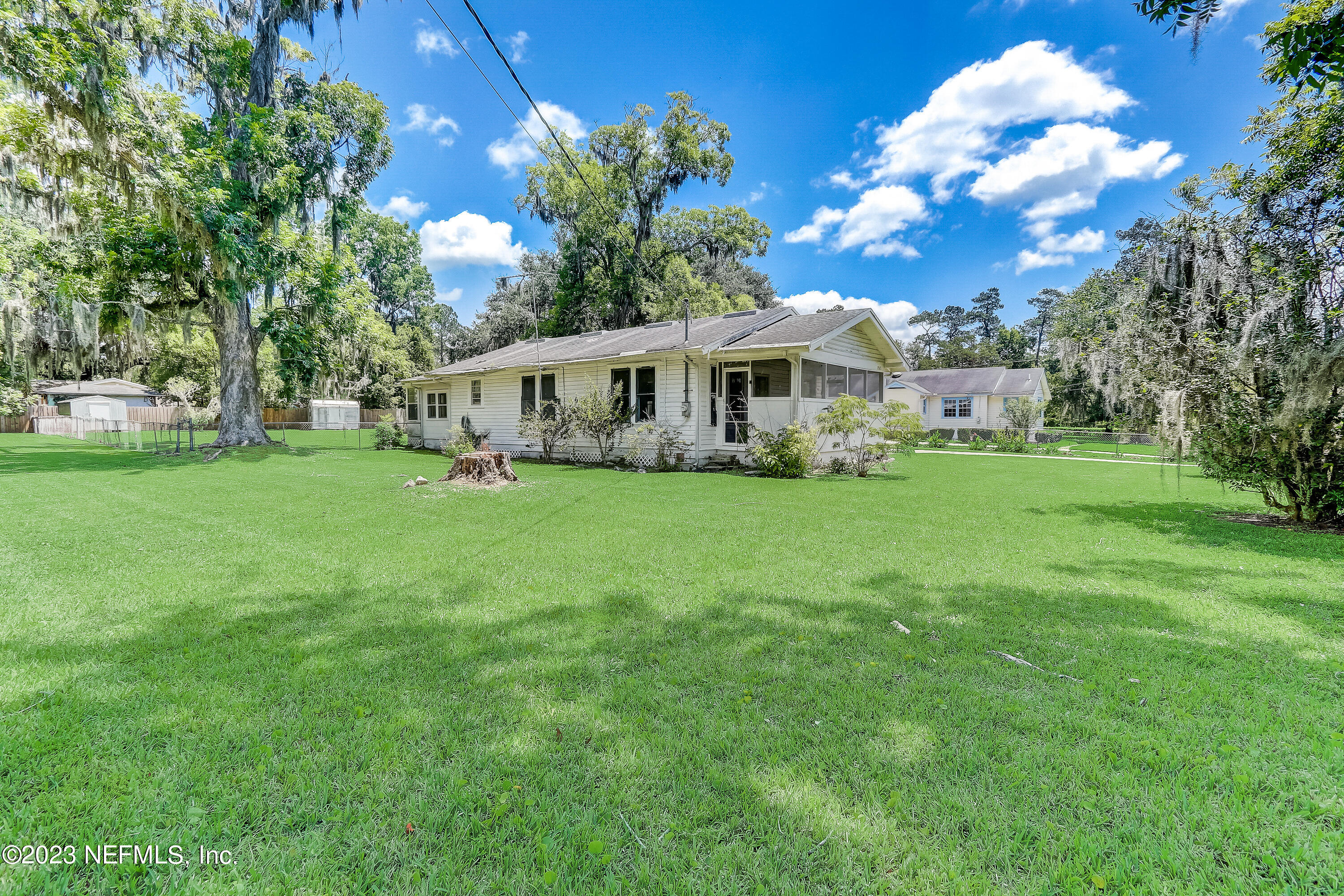 3547 Capper Road Jacksonville, FL 32218 - Photo 24 of 24 a view of house with a big yard and large trees