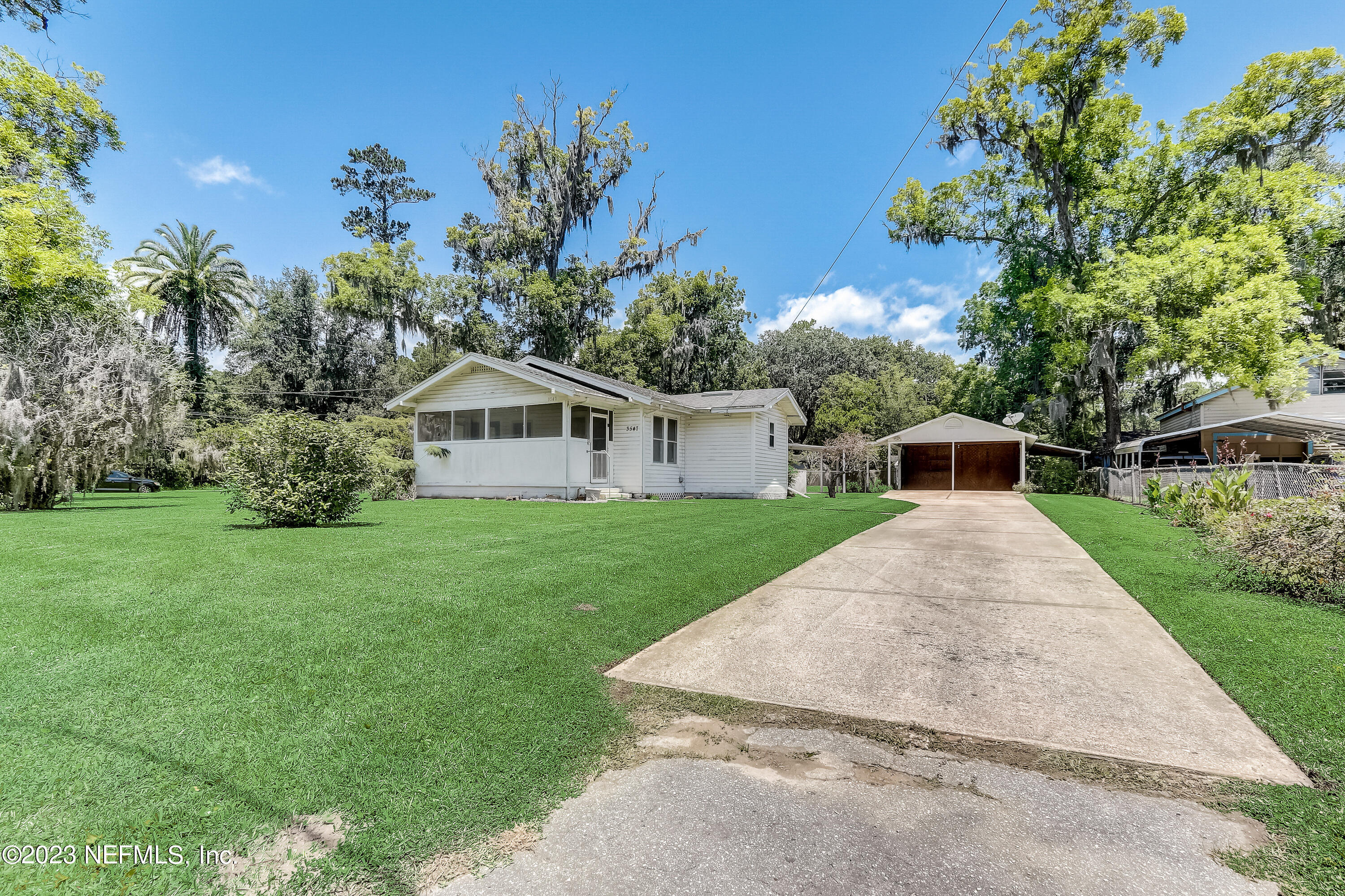 3547 Capper Road Jacksonville, FL 32218 - Photo 3 of 24 a house with green field in front of it