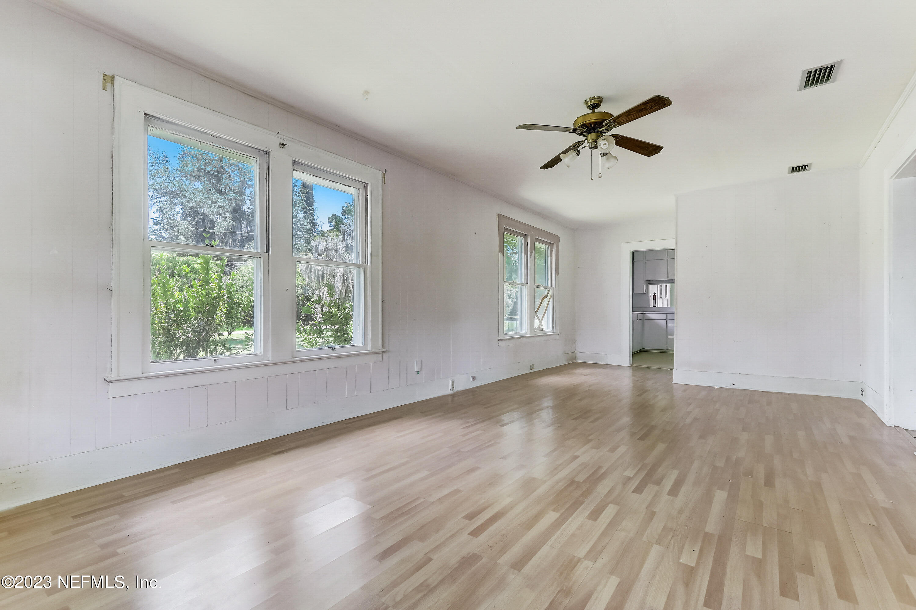 3547 Capper Road Jacksonville, FL 32218 - Photo 4 of 24 a view of empty room with wooden floor and fan