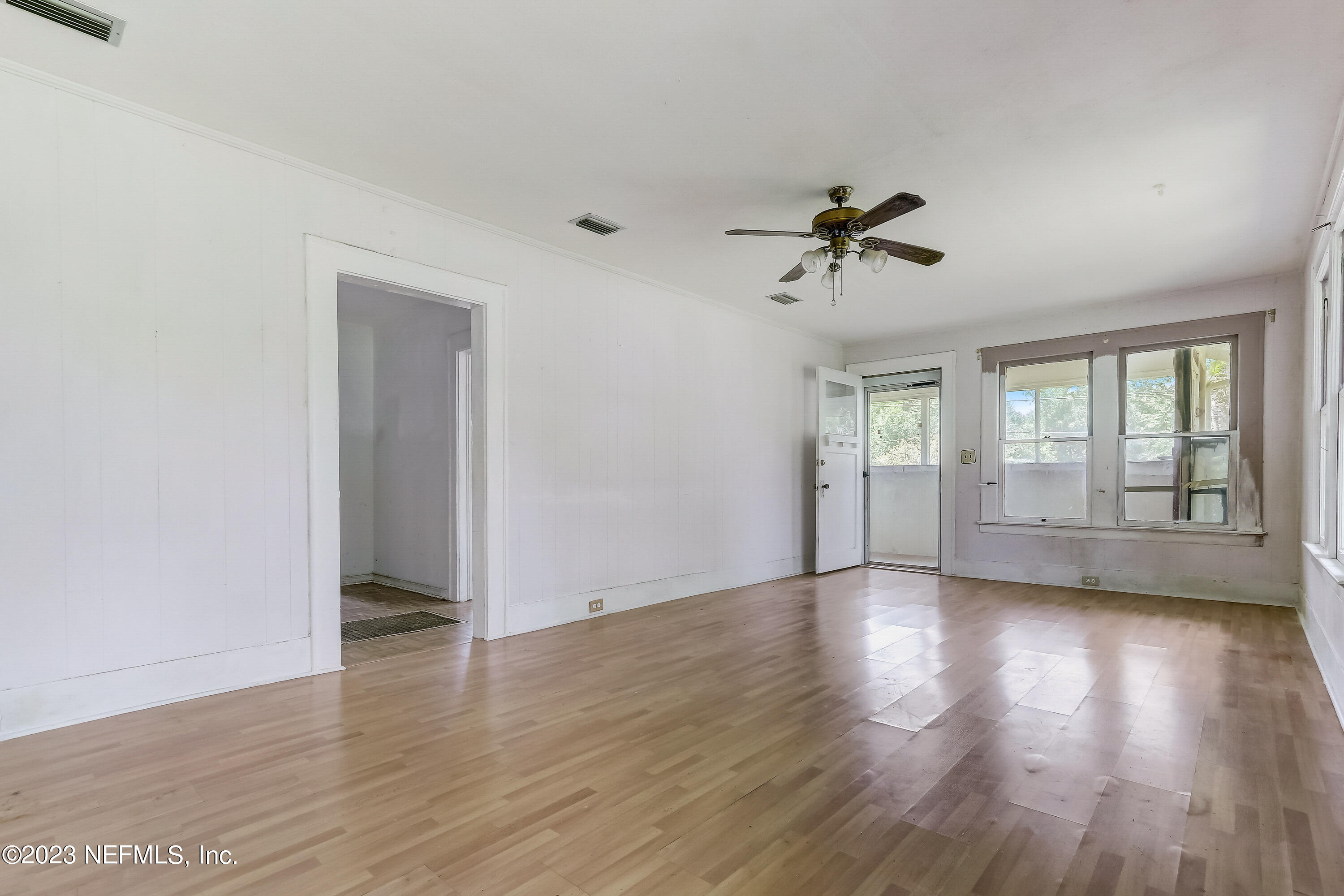 3547 Capper Road Jacksonville, FL 32218 - Photo 5 of 24 wooden floor in an empty room with a window