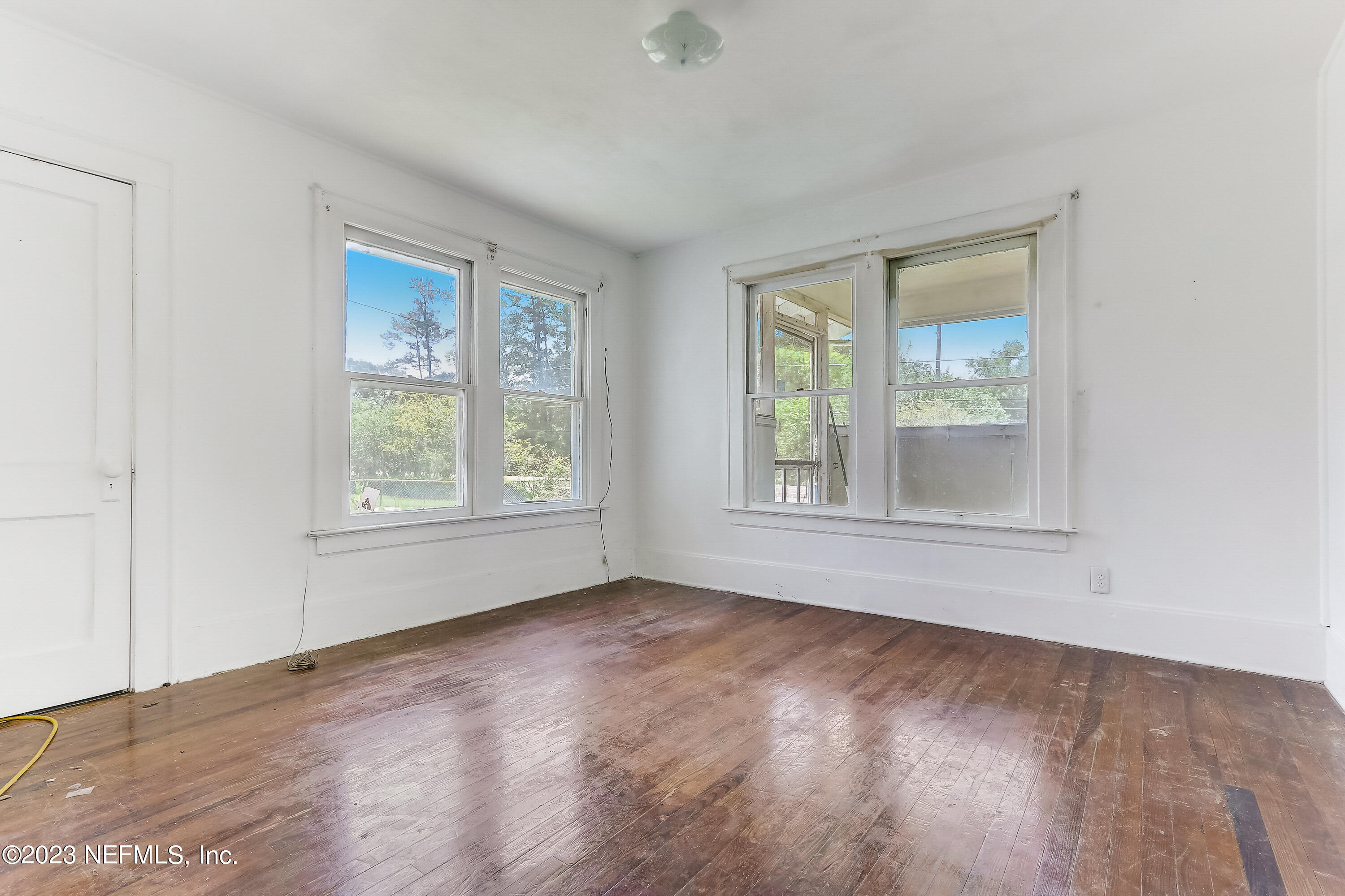 3547 Capper Road Jacksonville, FL 32218 - Photo 6 of 24 an empty room with wooden floor and windows