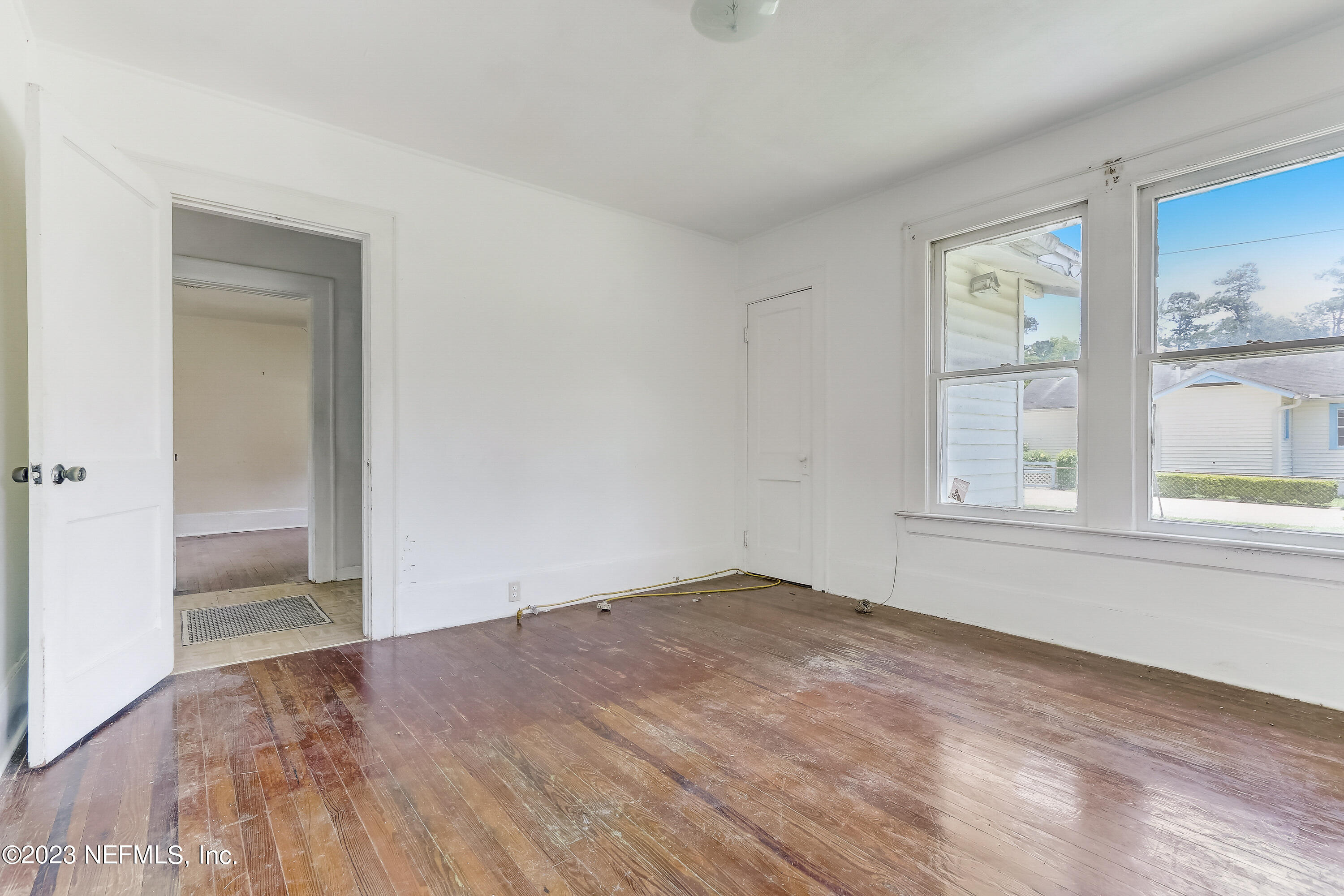 3547 Capper Road Jacksonville, FL 32218 - Photo 7 of 24 a view of an empty room with wooden floor and a window