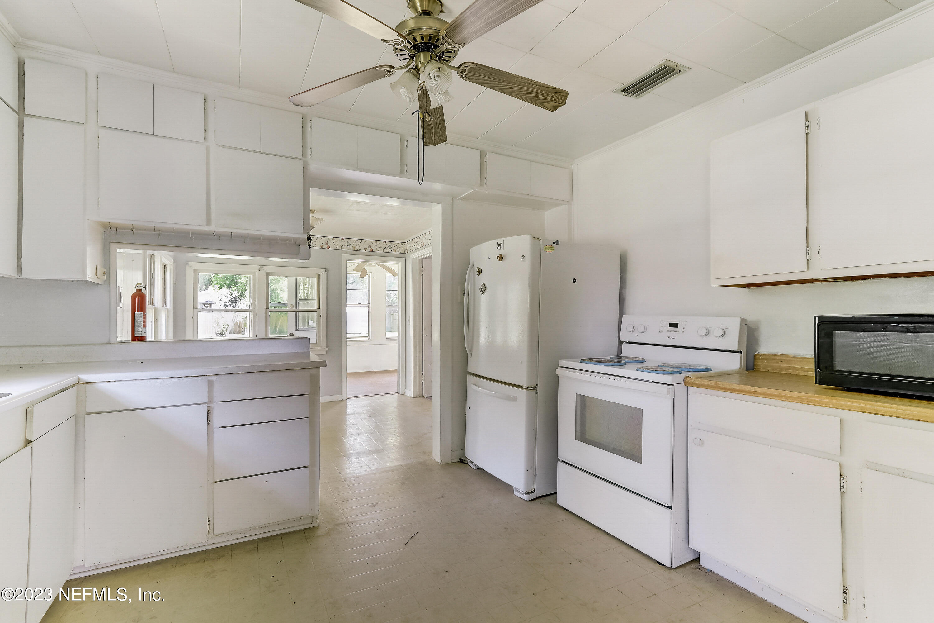 3547 Capper Road Jacksonville, FL 32218 - Photo 9 of 24 a kitchen with white cabinets and white appliances