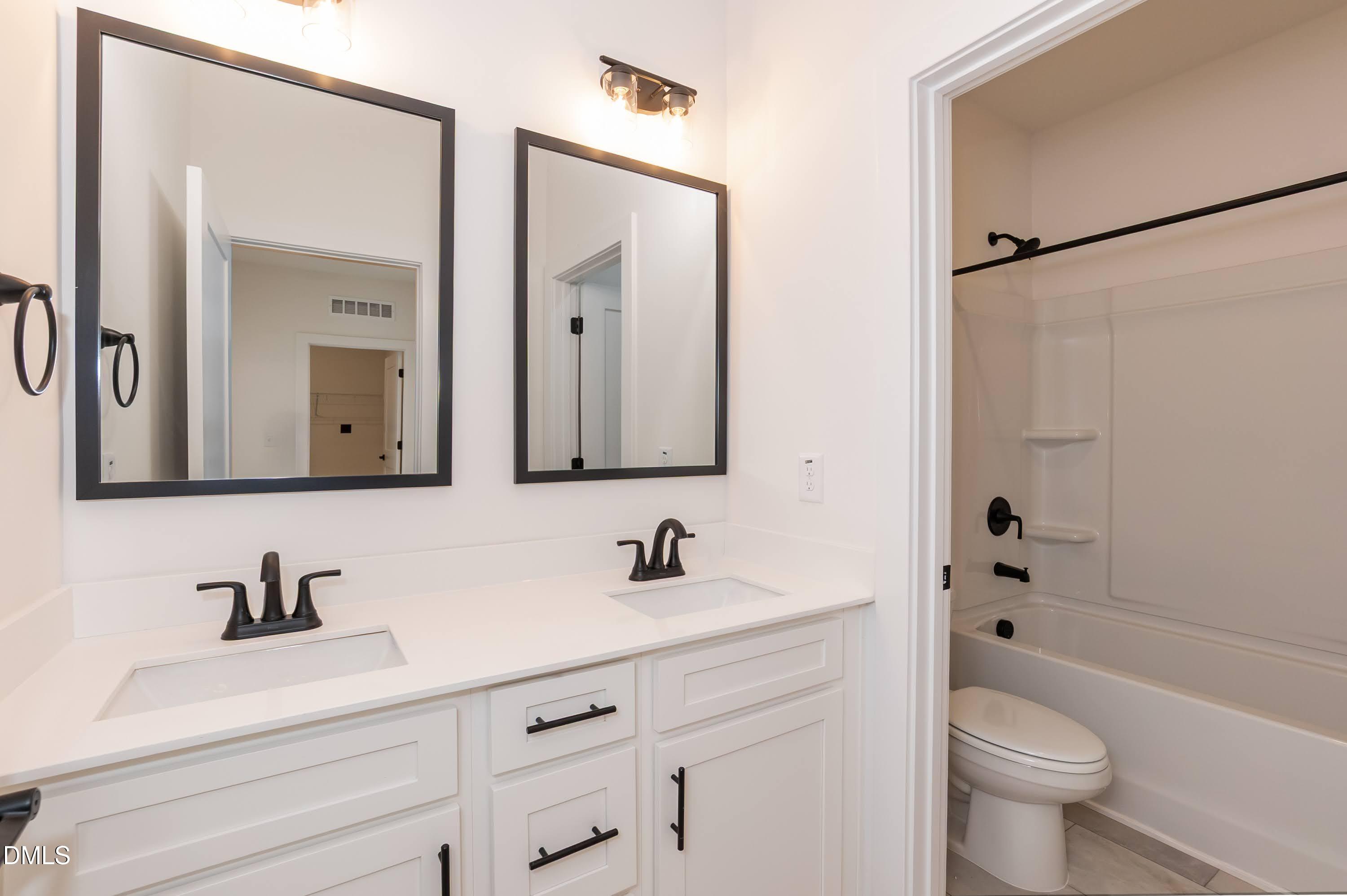 180 Galway Road Lillington, NC 27546 - Photo 30 of 41 a bathroom with a sink a toilet and a mirror