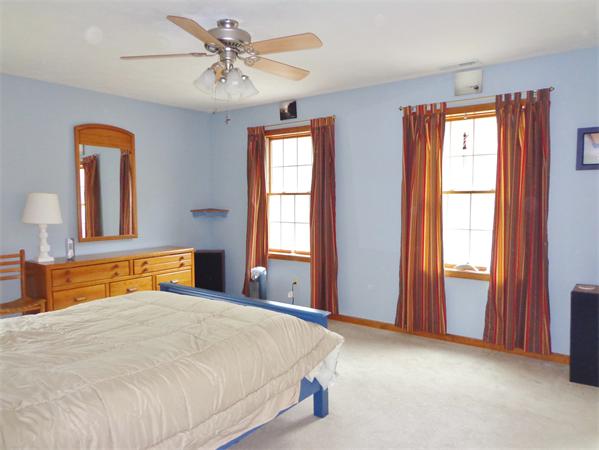 43 Old Poor Farm Road Ware, MA 01082 - Photo 20 of 29 a bedroom with a large bed and a chandelier