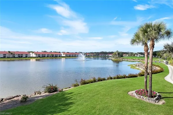 a view of a lake with houses in the back