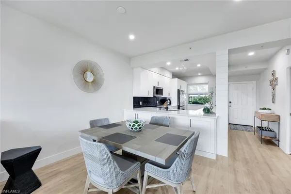a view of a dining room with furniture and wooden floor