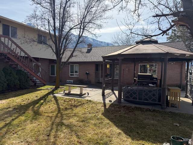 415 East Maple Street Mapleton, UT 84664 - Photo 4 of 19 Back of house with a gazebo, a patio area, a lawn, and a mountain views.
