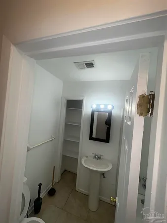 a bathroom with a sink and mirror