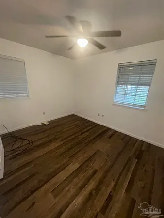 a view of room with wooden floor