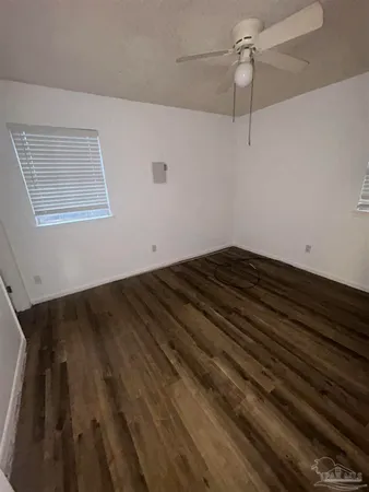 a view of room with hardwood floor and ceiling fan
